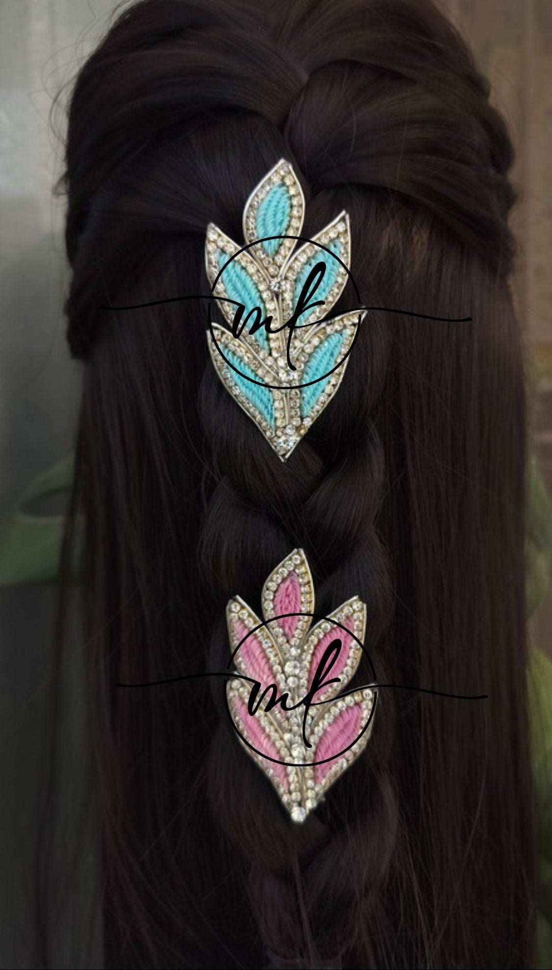 Two decorative hair pins with floral designs on braided hair against a neutral background